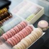 Rows of macarons behind a glass window at a patisserie
