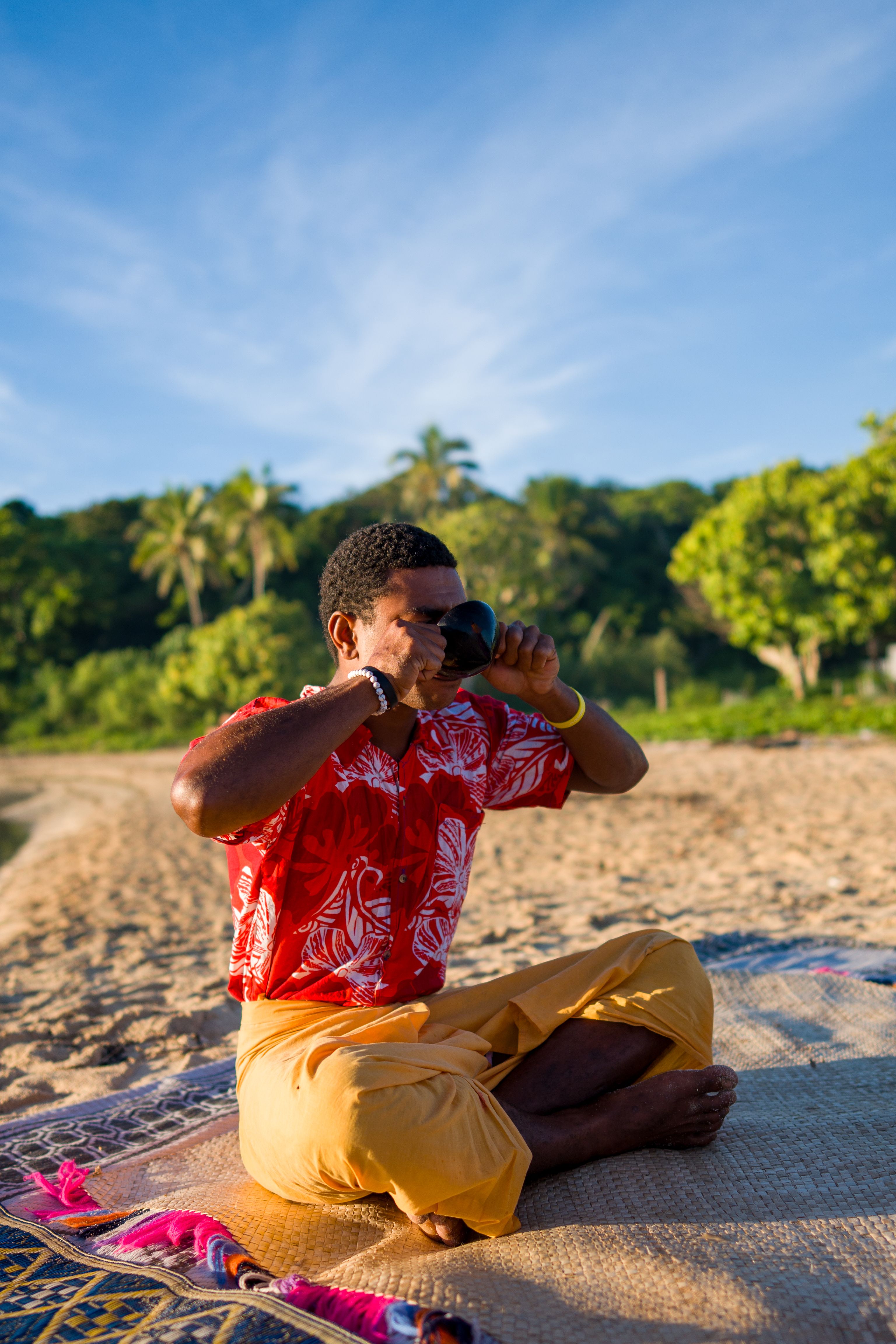 Sunset kava ceremony on a secluded Fiji beach, where tradition meets the tide.