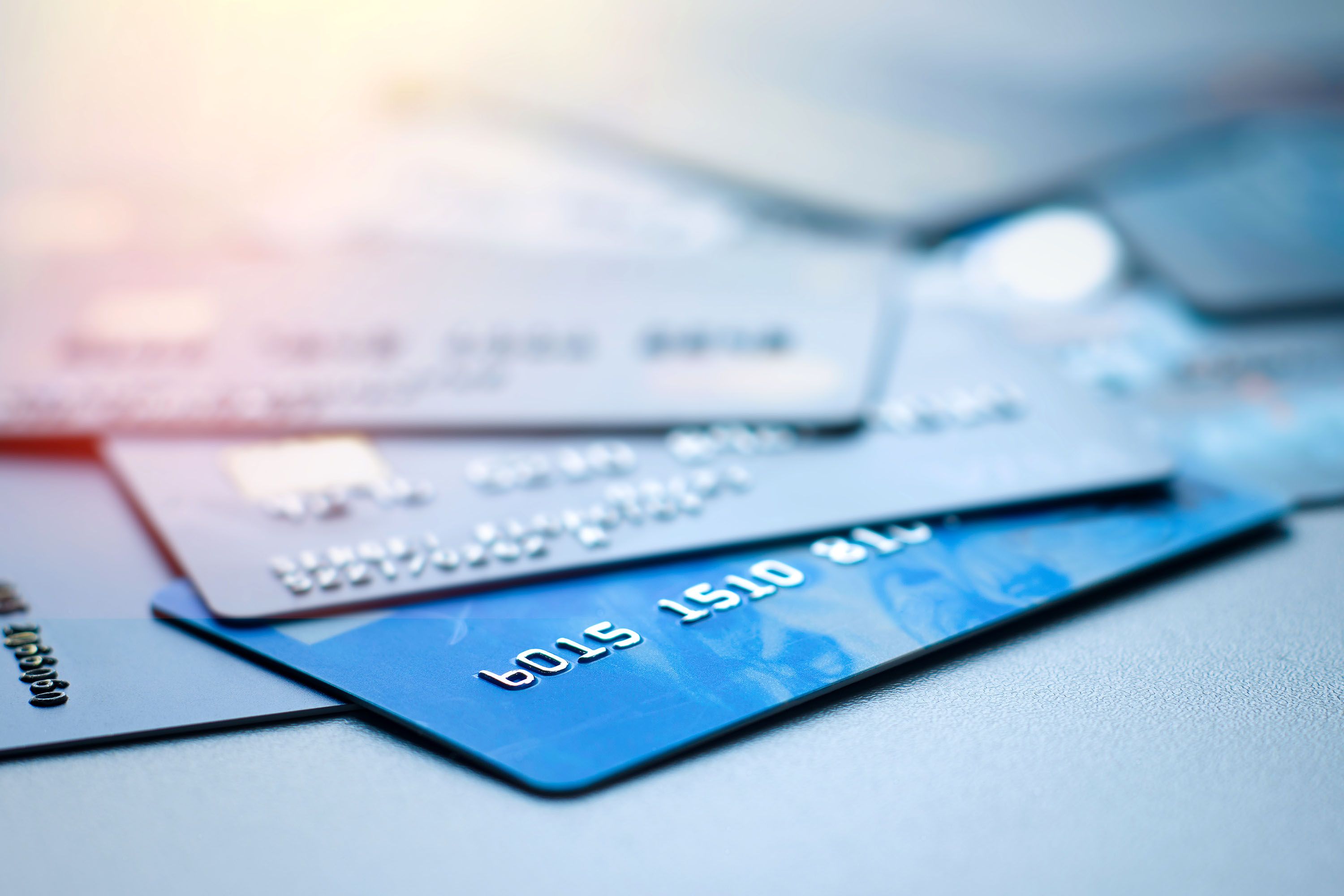 Four credit cards splayed out on a table.