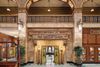 A grand marble entrance to an elegant spa and salon with ornate architectural details.