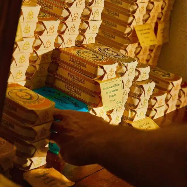 Stacks of canned fish in pretty, retro paper wrappers, on a shelf at the Lisbon food store, Conserveira de Lisboa