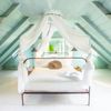 The attic bedroom, with mint-green walls and glossy white floor