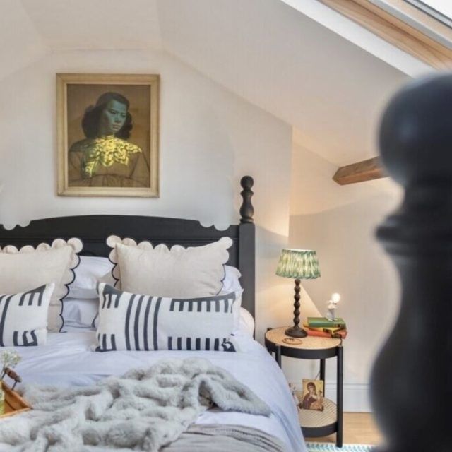 A bed in a Vrbo with pretty monochrome pillows