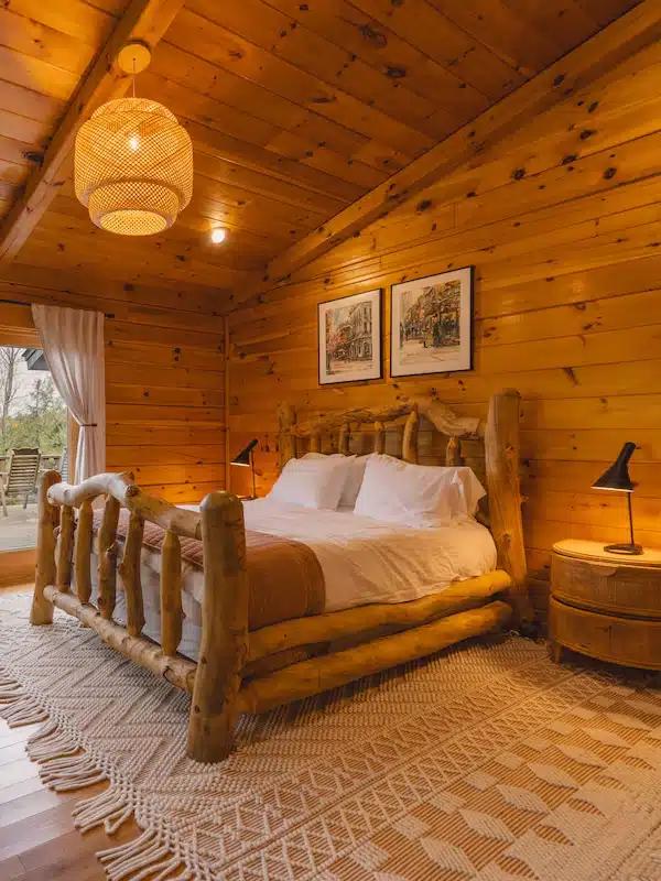 A rustic wooden bedroom in a cabin Vrbo in the Catskills