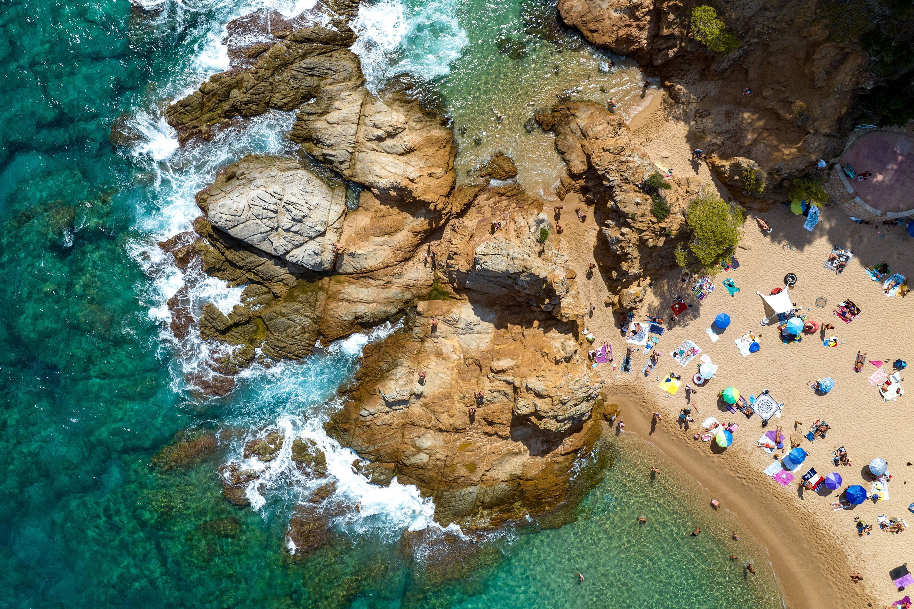 Aerial view of people on a beach in Lloret de Mar in Spain.