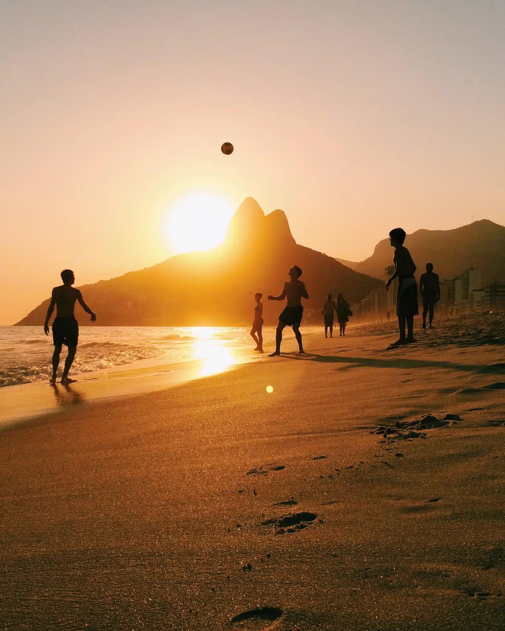A group of people playing football on Ipanema beach, Rio de Janeiro