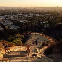 View of Los Angeles and people hiking up Runyon Canyon Trail