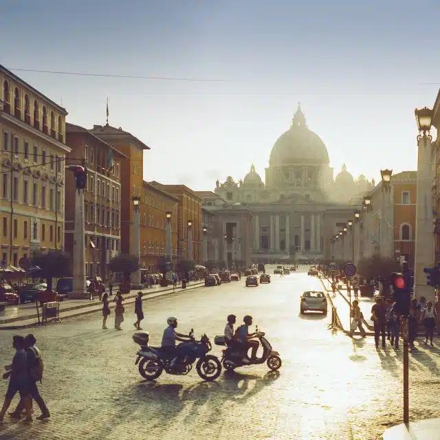 Saint Peter's Basilica in the Vatican City, silhouetted against the sun