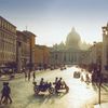 Saint Peter's Basilica in the Vatican City, silhouetted against the sun