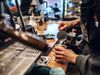 A barista pours steamed milk onto a coffee drink.