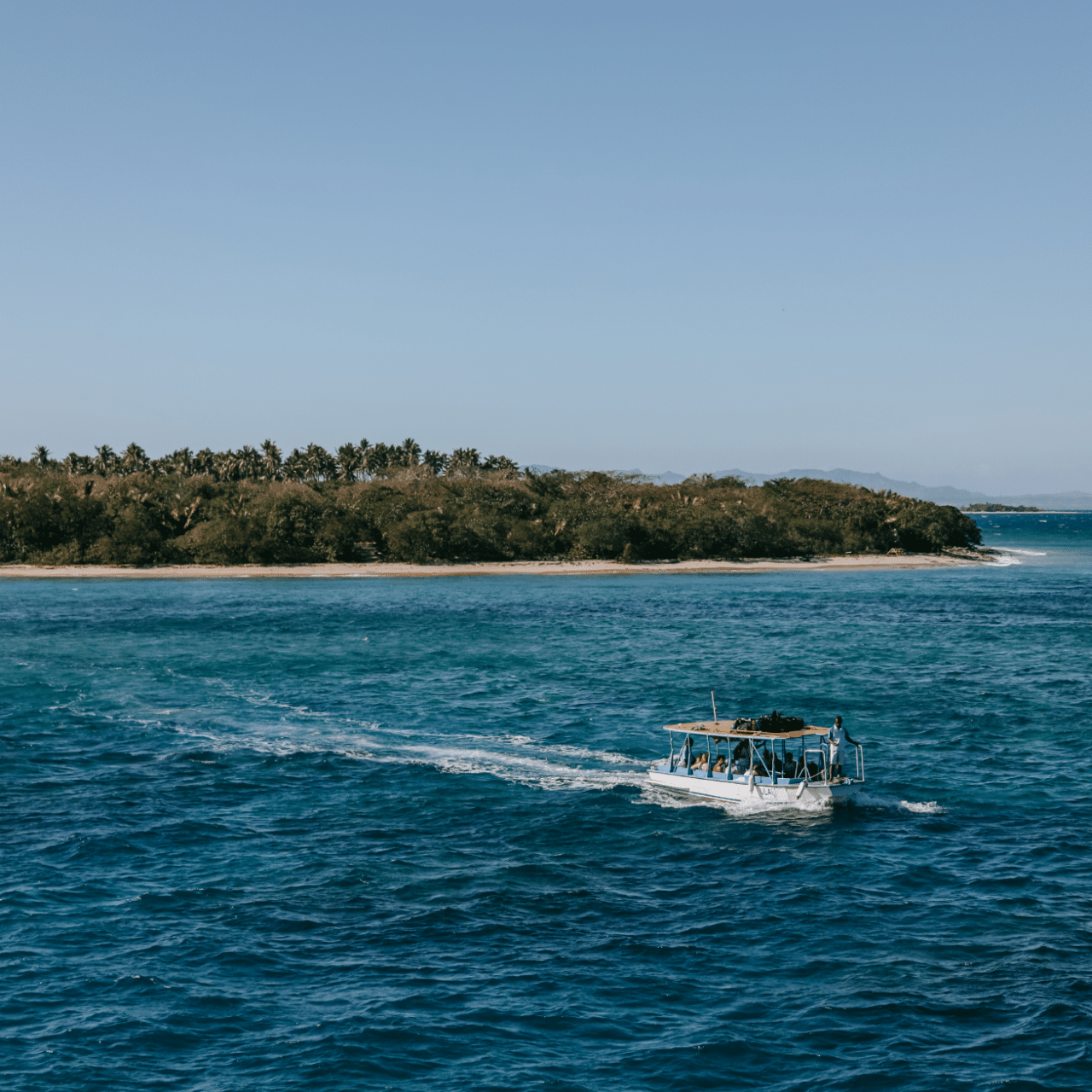 A boat sails away from the shore in Punta Cana, Dominican Republic