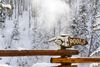 A finger arrow sign pointing to hot spring pools in the snow.