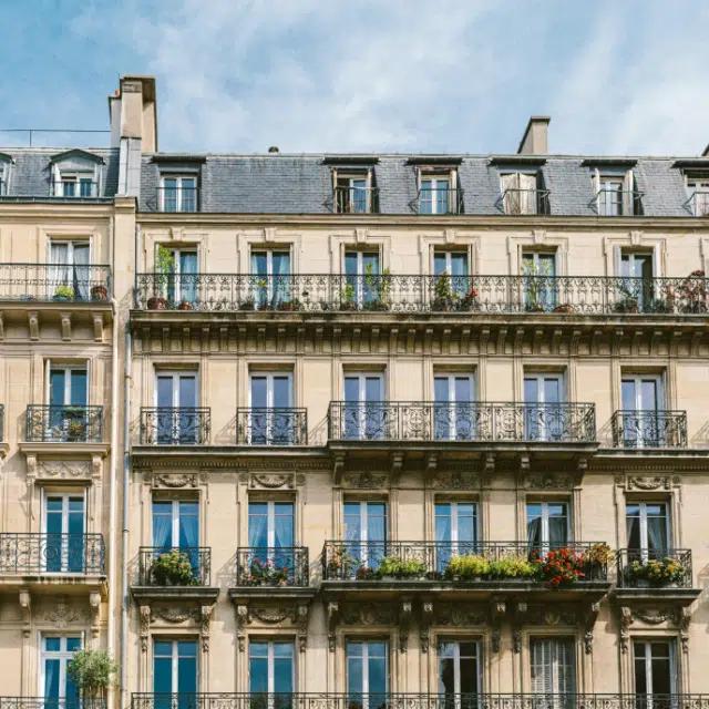 A typical Parisian building, with wrought iron balconies and a grey roof