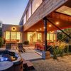 The garden area and hot tub of a mid-century Vrbo rental chalet in Winter Park, Colorado