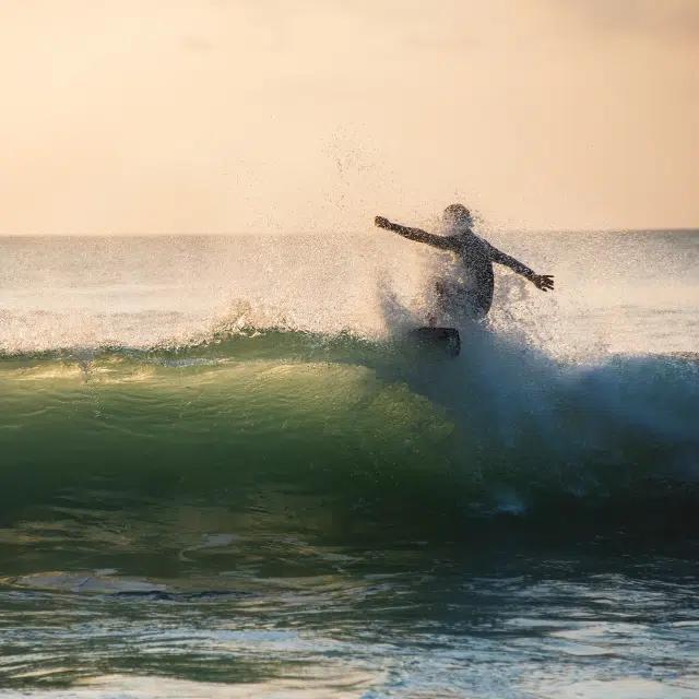 A surfer rides a wave