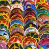 Stacks of neatly arranged dishes, decorated in brightly colors, on a market stall