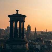 Edinburgh's Calton Hill, seen at sunset, with the spires of the city beyond