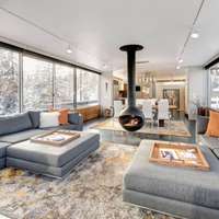 The living room with a modern fireplace at a Vrbo rental chalet in Winter Park, Colorado