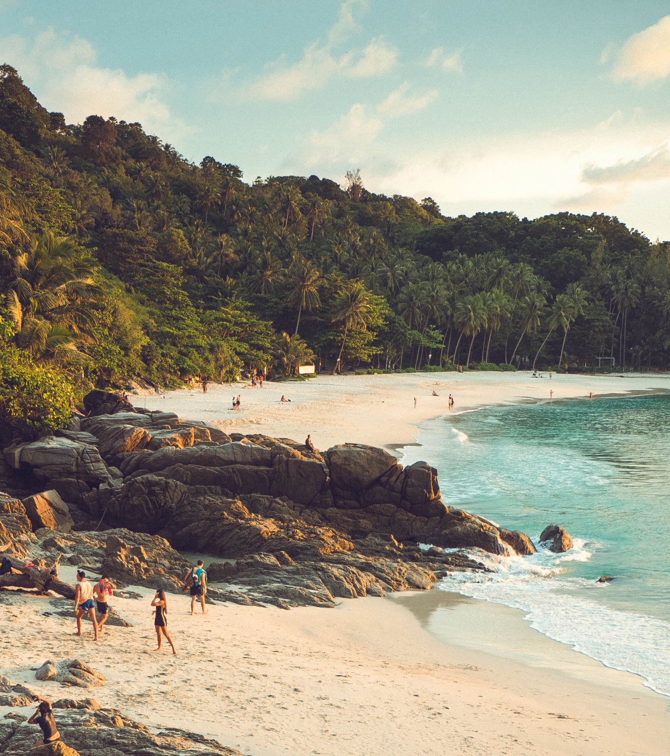 The white sand and lush green slopes of Freedom Beach, Phuket, Thailand