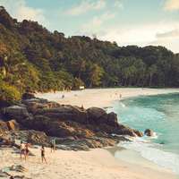 The white sand and lush green slopes of Freedom Beach, Phuket, Thailand