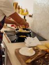 A close up of a person cooking at a stove