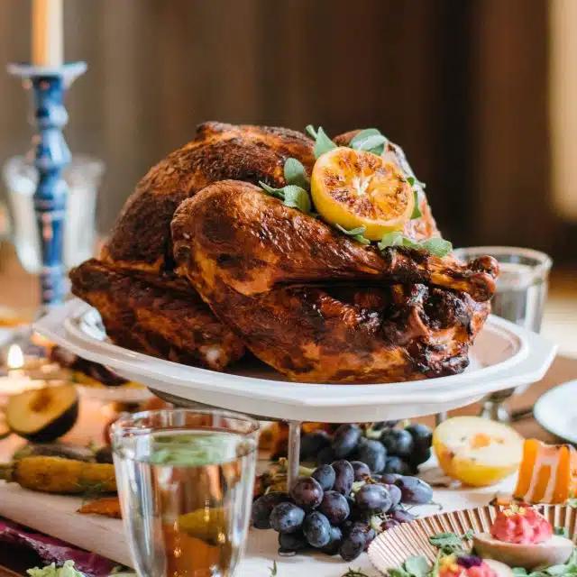 A turkey on a platter on a decorated dining table