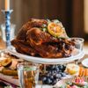 A turkey on a platter on a decorated dining table