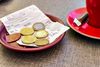 Euro notes left as a tip rest on a receipt atop a plate on a table