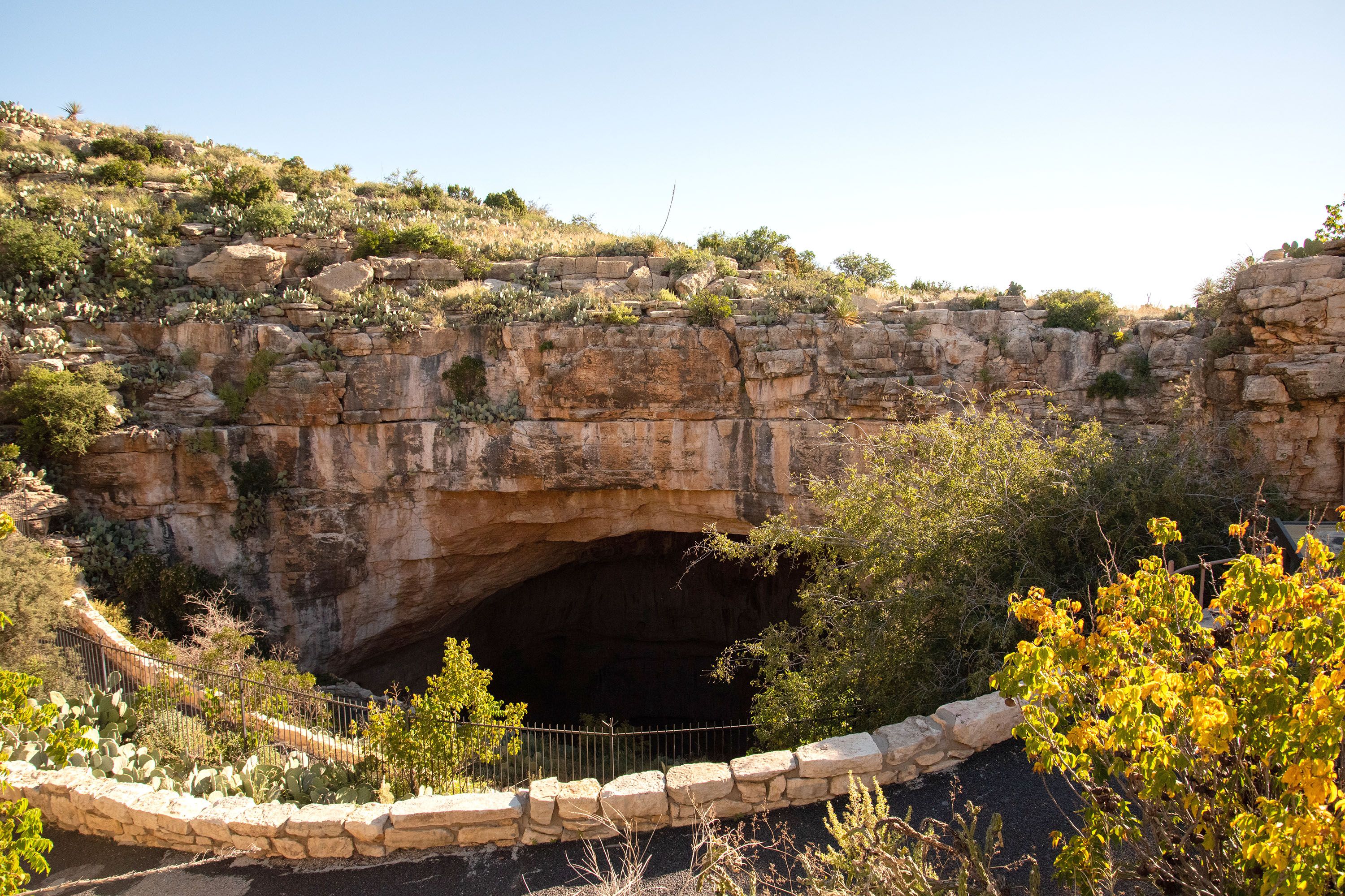 A hanging bridge in front of a cavern.