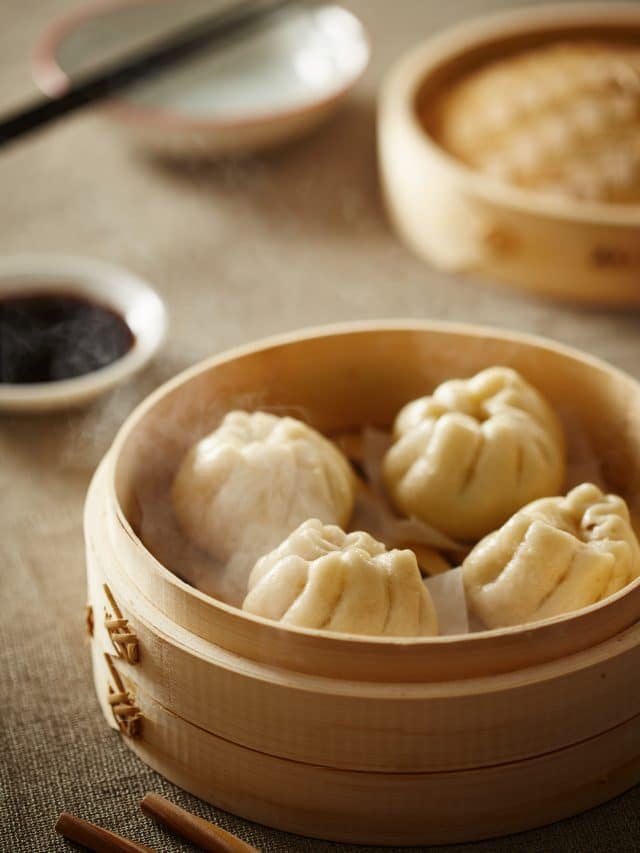 Steamed bao buns are served in a steamer in Chinatown in New York City