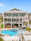A huge Vrbo in Holden Beach, NC, with a pool that has a shallow section and a beach entry