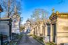 Cobbled alley lined with graves at Pere Lachaise Cemetery in Paris