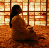 A woman sits cross-legged in a salt chamber at Spa L.A.