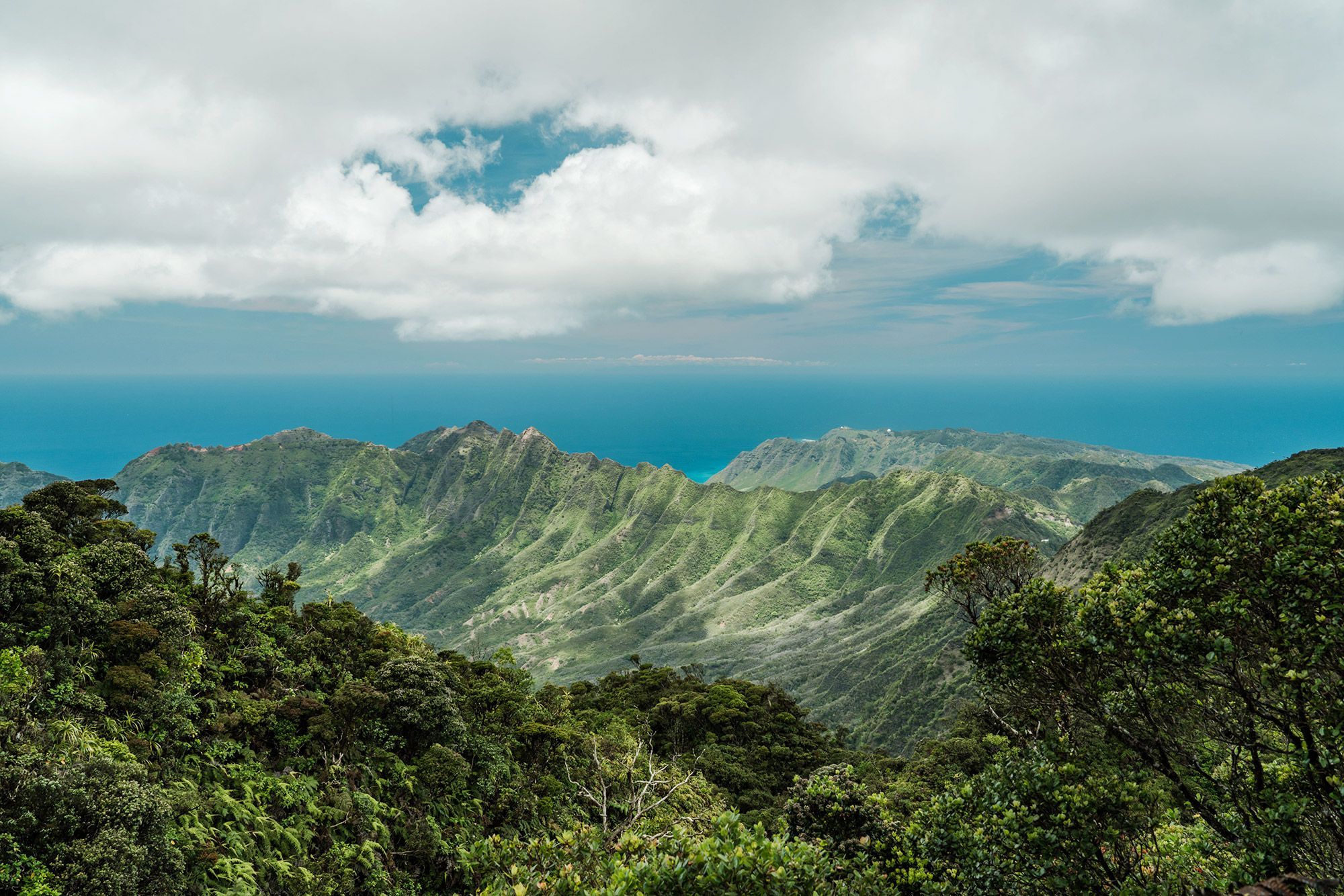 Mount Kaʻala of the Waianae mountain range in Oahu with sun and clouds.