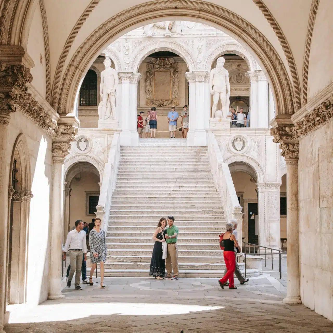 Visitors admire the Venetian Gothic architecture at the Doge’s Palace in Venice, Italy