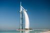 View of the Burj Al Arab hotel in Dubai, showcasing its sail-shaped architecture beside the Arabian Gulf.