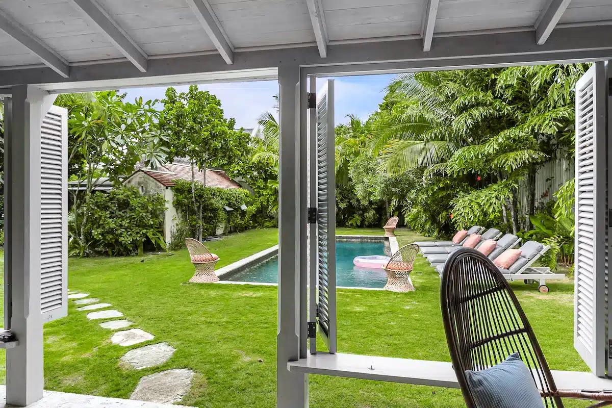 The saltwater pool, with loungers along one side, surrounded by a lush garden