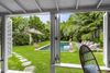 The saltwater pool, with loungers along one side, surrounded by a lush garden