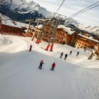 People ski beneath the Alpauris lift, nicknamed the "scare chair," in Alpe d'Huez in France