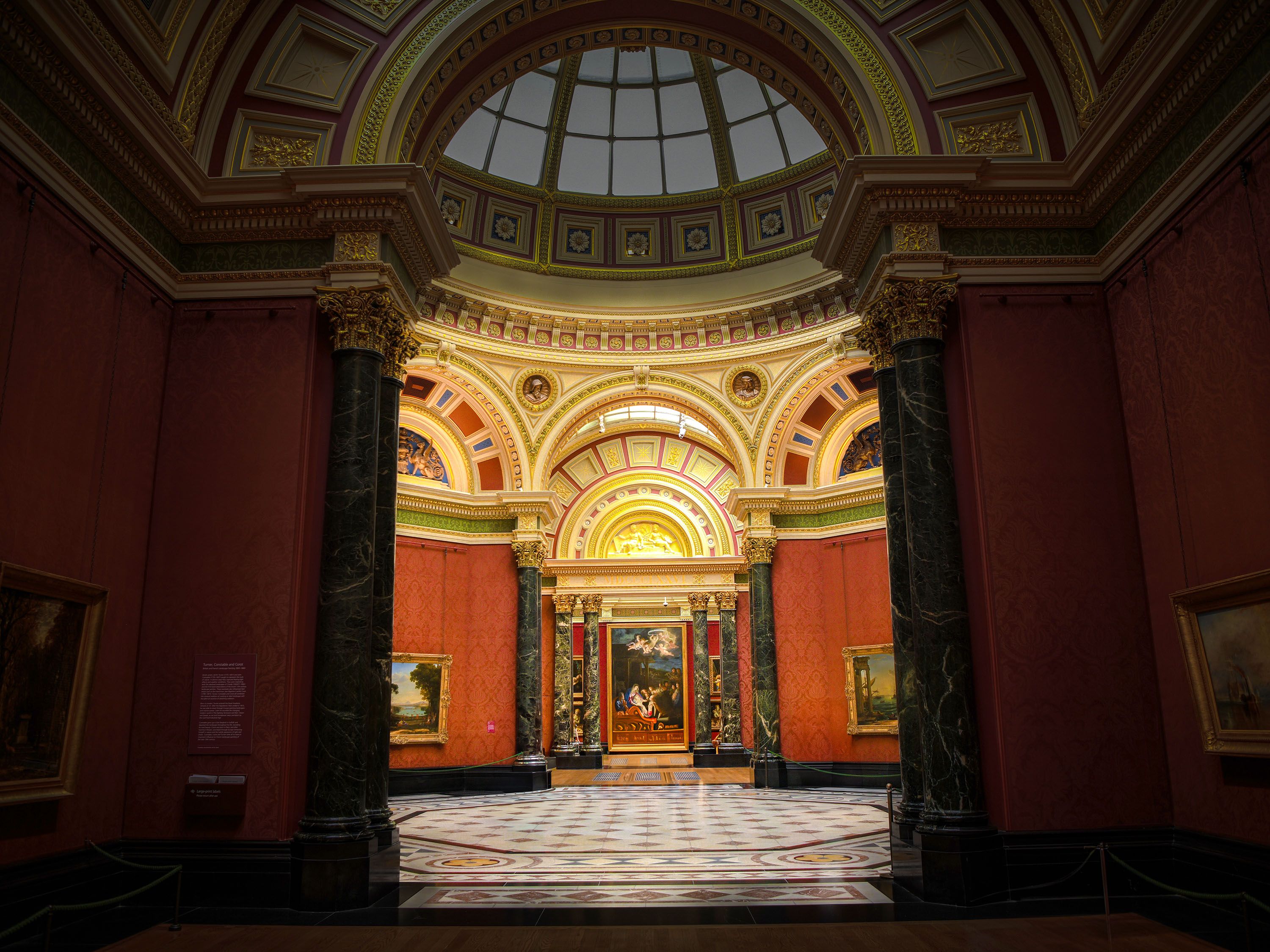 View through a doorway into a domed room filled with art.