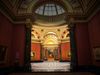 View through a doorway into a domed room filled with art.