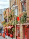 The exterior of a pub adorned with planters filled with flowers in Dublin, Ireland
