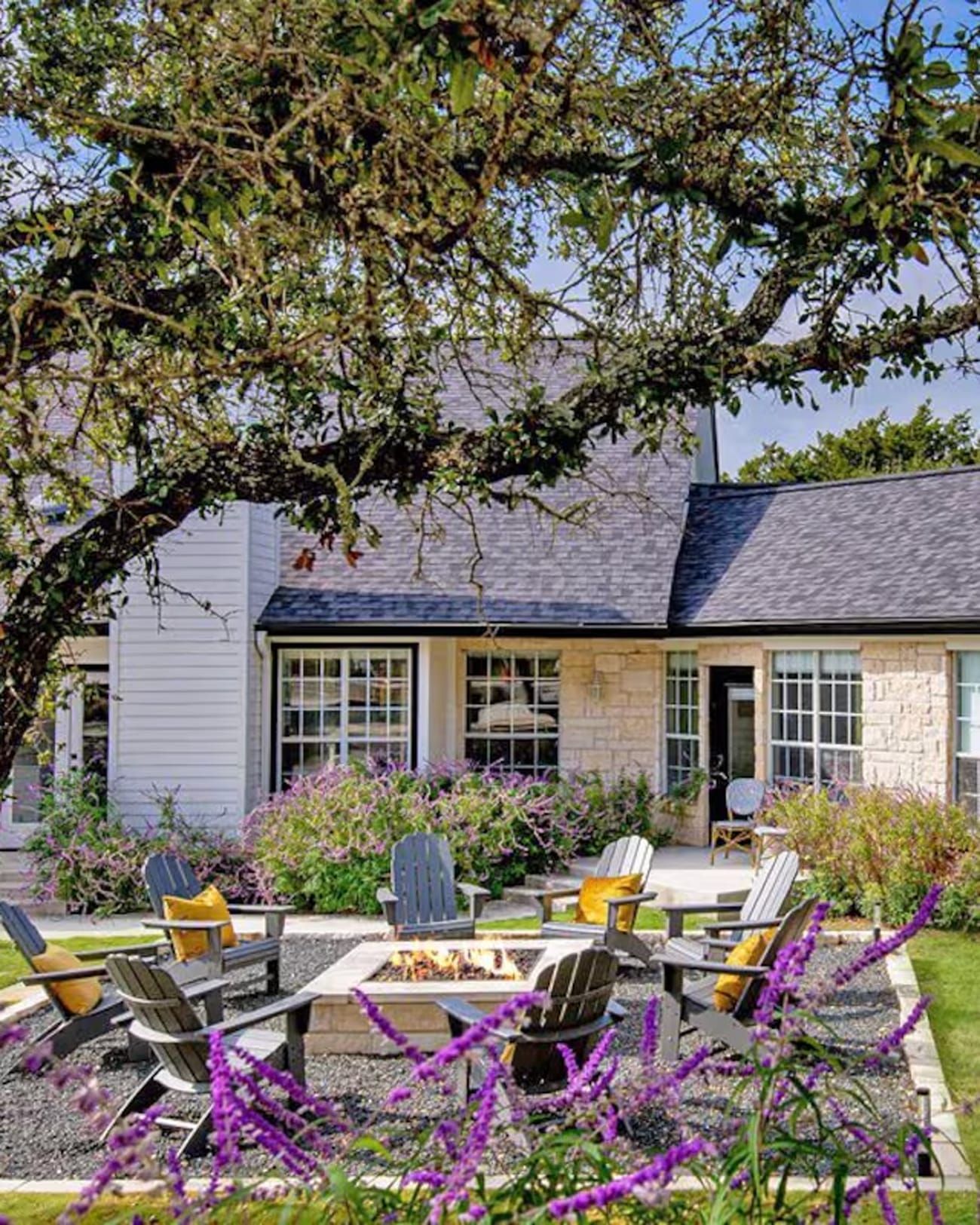 Adirondacks surround a fire pit beside a vast Vrbo near Austin, Texas