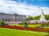 Flower garden in front of Buckingham Palace with statue.