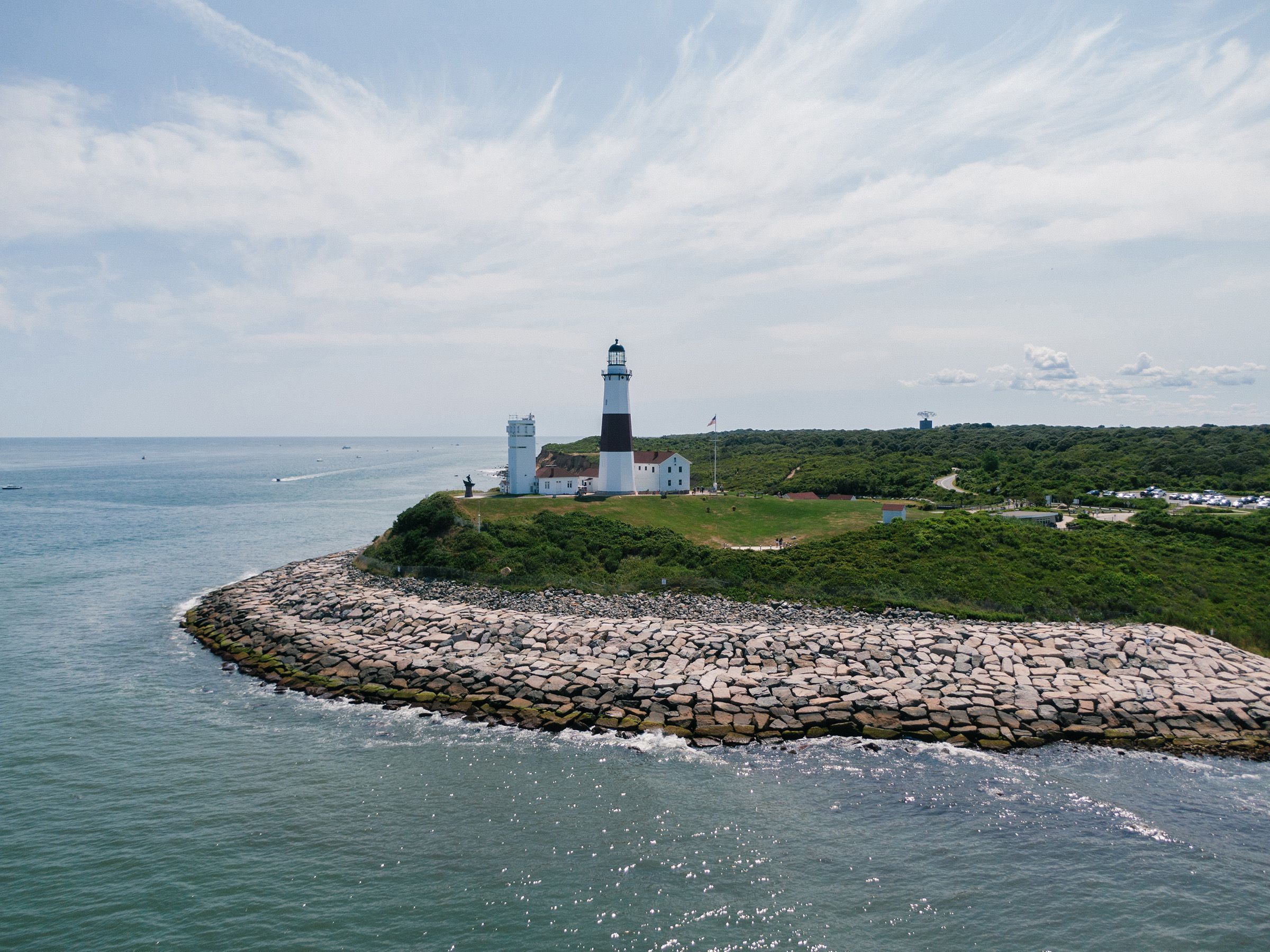 Montauk Lighthouse On A Steep Hill Over Foamy Ocean, NY, USA