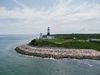 Montauk Lighthouse On A Steep Hill Over Foamy Ocean, NY, USA