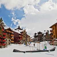 Brightly colored, snow-covered chalets in Les Arcs, France