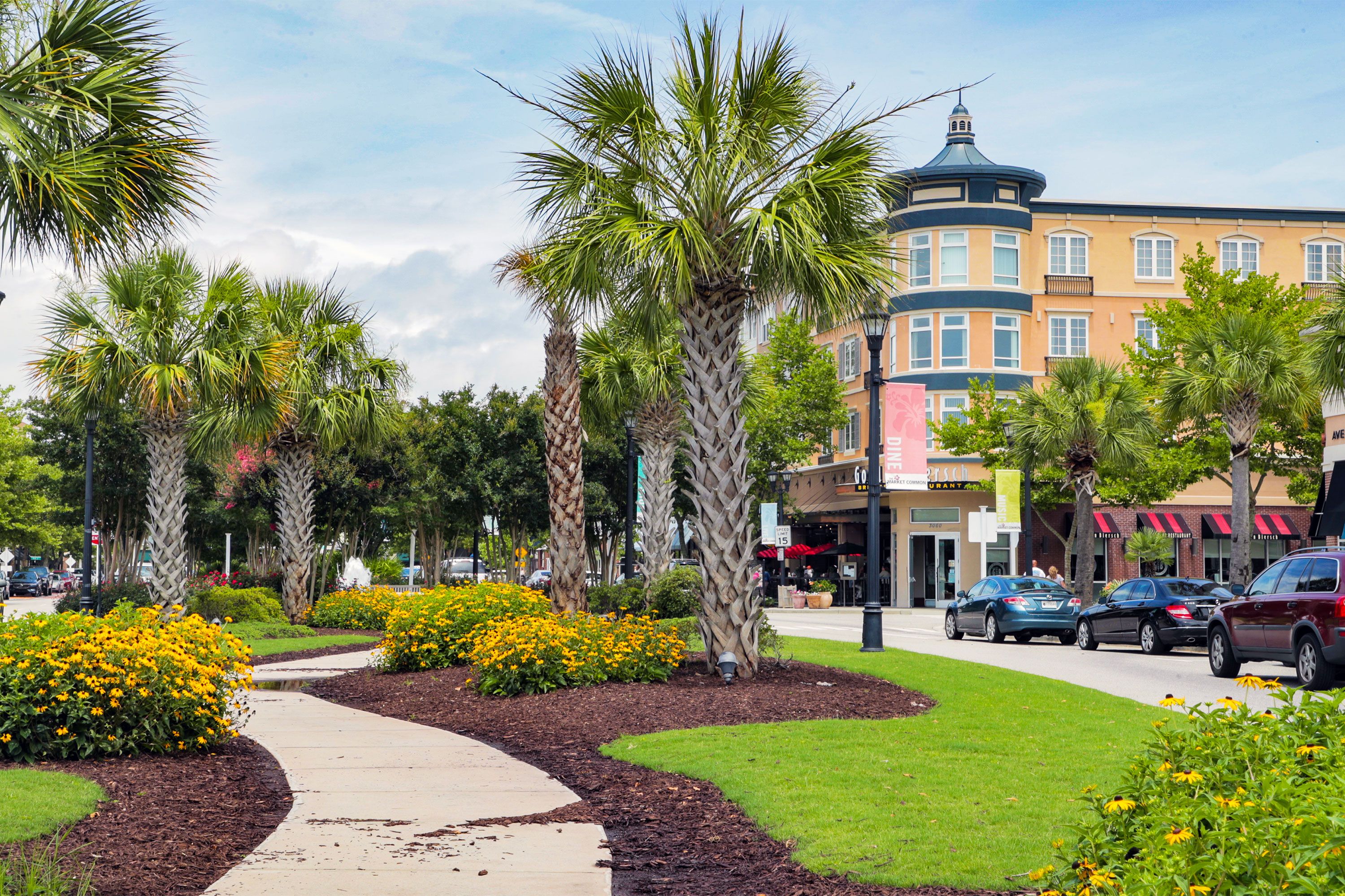 Palm-lined sidewalk and storefronts at Market Common in Myrtle Beach.