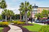 Palm-lined sidewalk and storefronts at Market Common in Myrtle Beach.