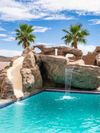 A rock feature with inbuilt slide beside a pool in Hurricane, Utah